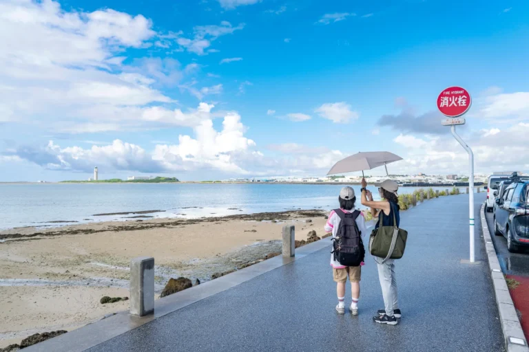 A person taking photos at Umikaji Terrace in the rain