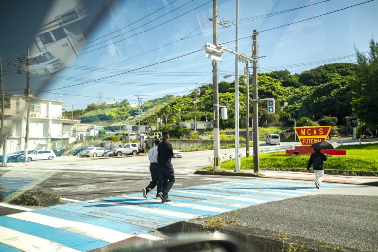 The weather in Okinawa on 22nd November 2025: A US soldier passing by with a sushi set.