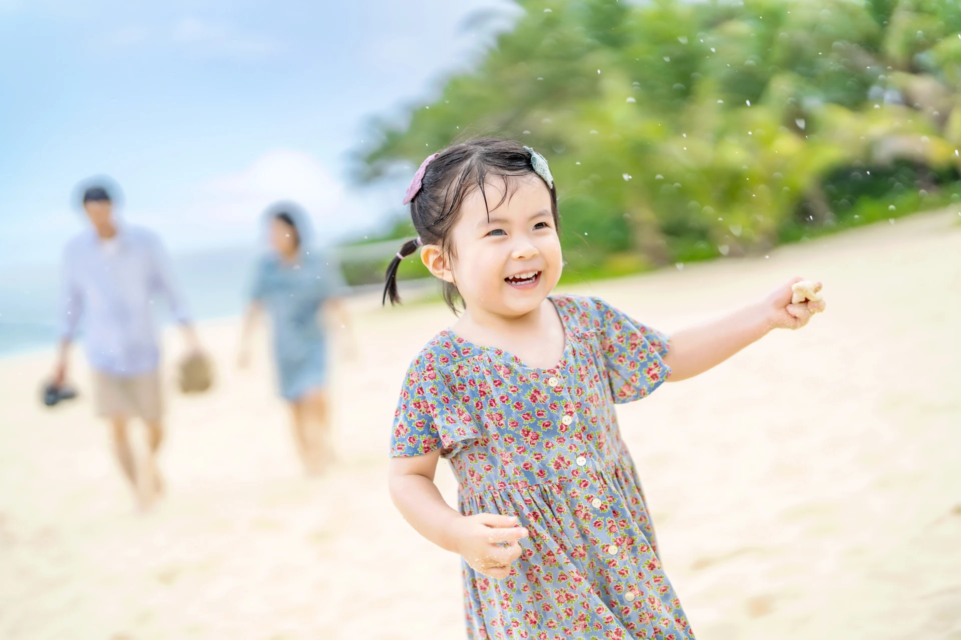 해변에서 웃으며 손짓하는 아이